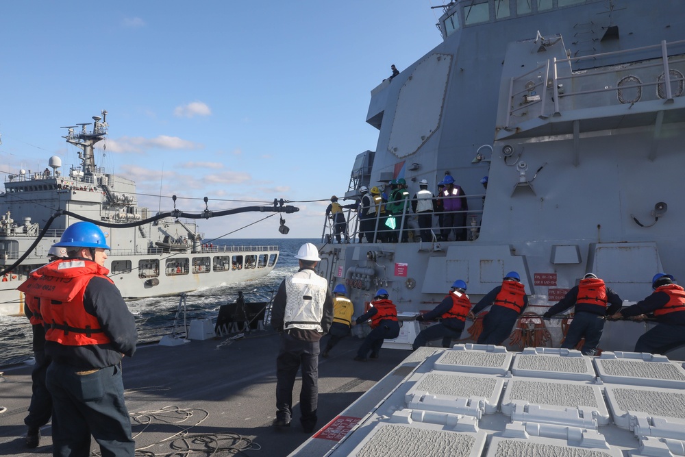 Sailors aboard the USS Rafael Peralta (DDG 115) prepare to conduct a replenishment-at-sea with the Republic of Korea’s combat support ship Dae Cheong (AOE 58)