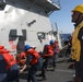 Sailors aboard the USS Rafael Peralta (DDG 115) conduct a replenishment-at-sea with Royal Canadian Navy supply ship MV Asterix in the Sea of Japan