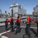 Sailors aboard the USS Rafael Peralta (DDG 115) conduct a replenishment-at-sea with Royal Canadian Navy supply ship MV Asterix in the Sea of Japan