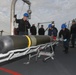 Sailors aboard the USS Rafael Peralta (DDG 115) conduct a torpedo download on the aft missile deck in the Sea of Japan