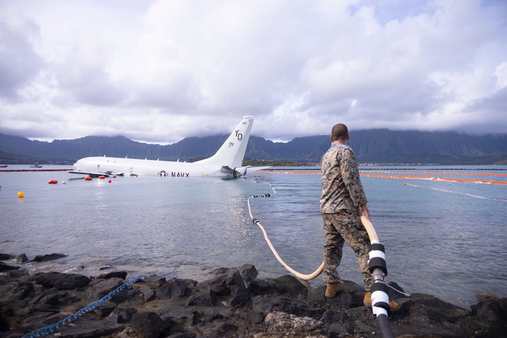 Defueling Operations are conducted on downed U.S. Navy P-8A Poseidon