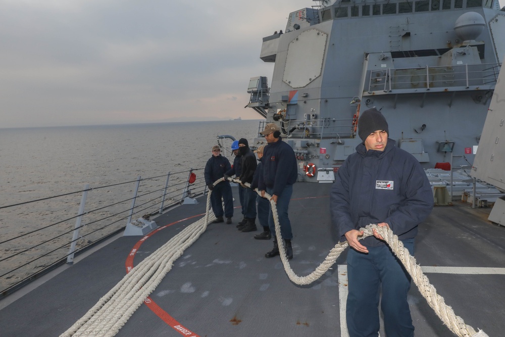 Sailors aboard the USS Rafael Peralta (DDG 115) conduct sea and anchor detail in Yokosuka, Japan