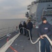 Sailors aboard the USS Rafael Peralta (DDG 115) conduct sea and anchor detail in Yokosuka, Japan