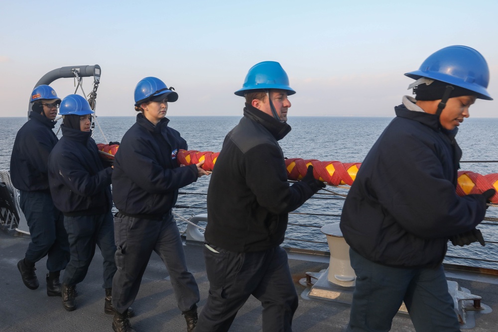 Sailors aboard the USS Rafael Peralta (DDG 115) conduct sea and anchor detail in Yokosuka, Japan