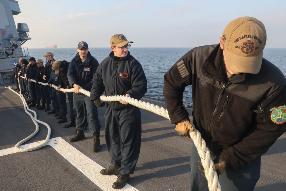 Sailors aboard the USS Rafael Peralta (DDG 115) conduct sea and anchor detail in Yokosuka, Japan