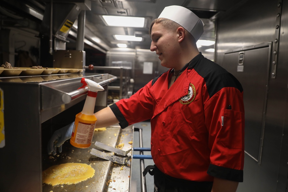 Sailors aboard the USS Rafael Peralta (DDG 115) prepare breakfast for the crew in the Taiwan Strait