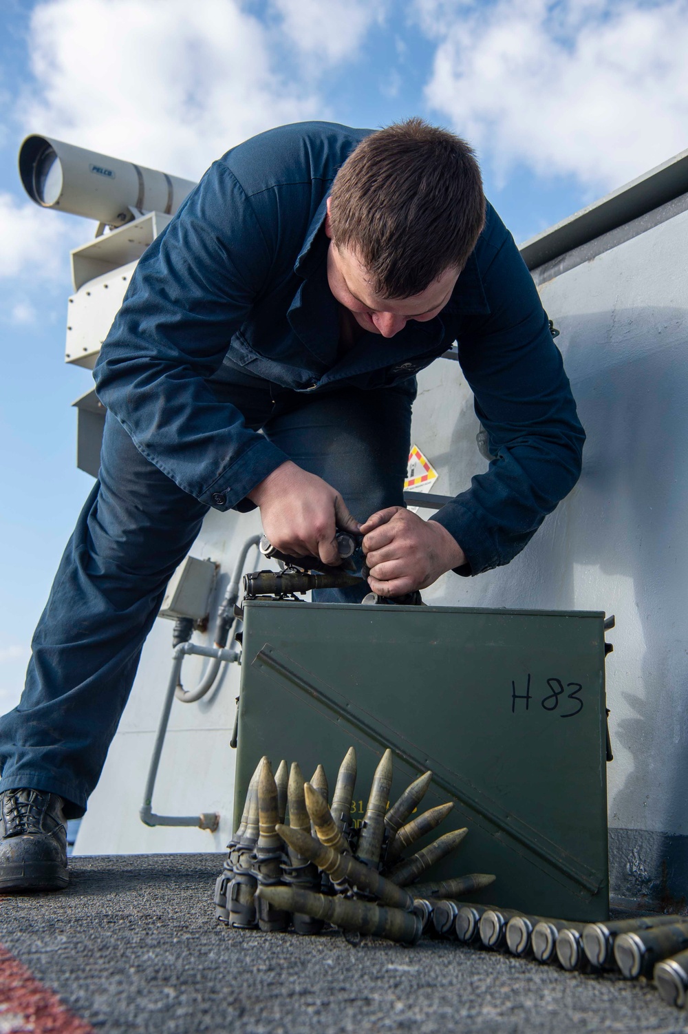 USS Kidd (DDG 100) Sailor Loads Close-In Weapons System (CIWS)