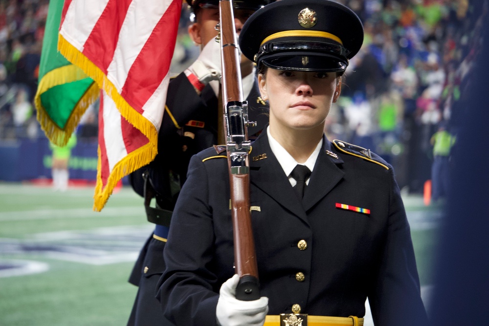 Washington National Guard service members service color guard during Thanksgiving game at Lumen Field