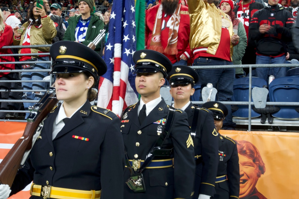 Washington National Guard service members service color guard during Thanksgiving game at Lumen Field