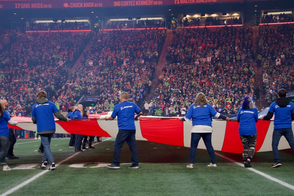 Washington National Guard service members service color guard during Thanksgiving game at Lumen Field