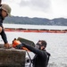 Experts prepare a U.S. Navy P-8A Poseidon in Kaneohe Bay for Salvage Operations