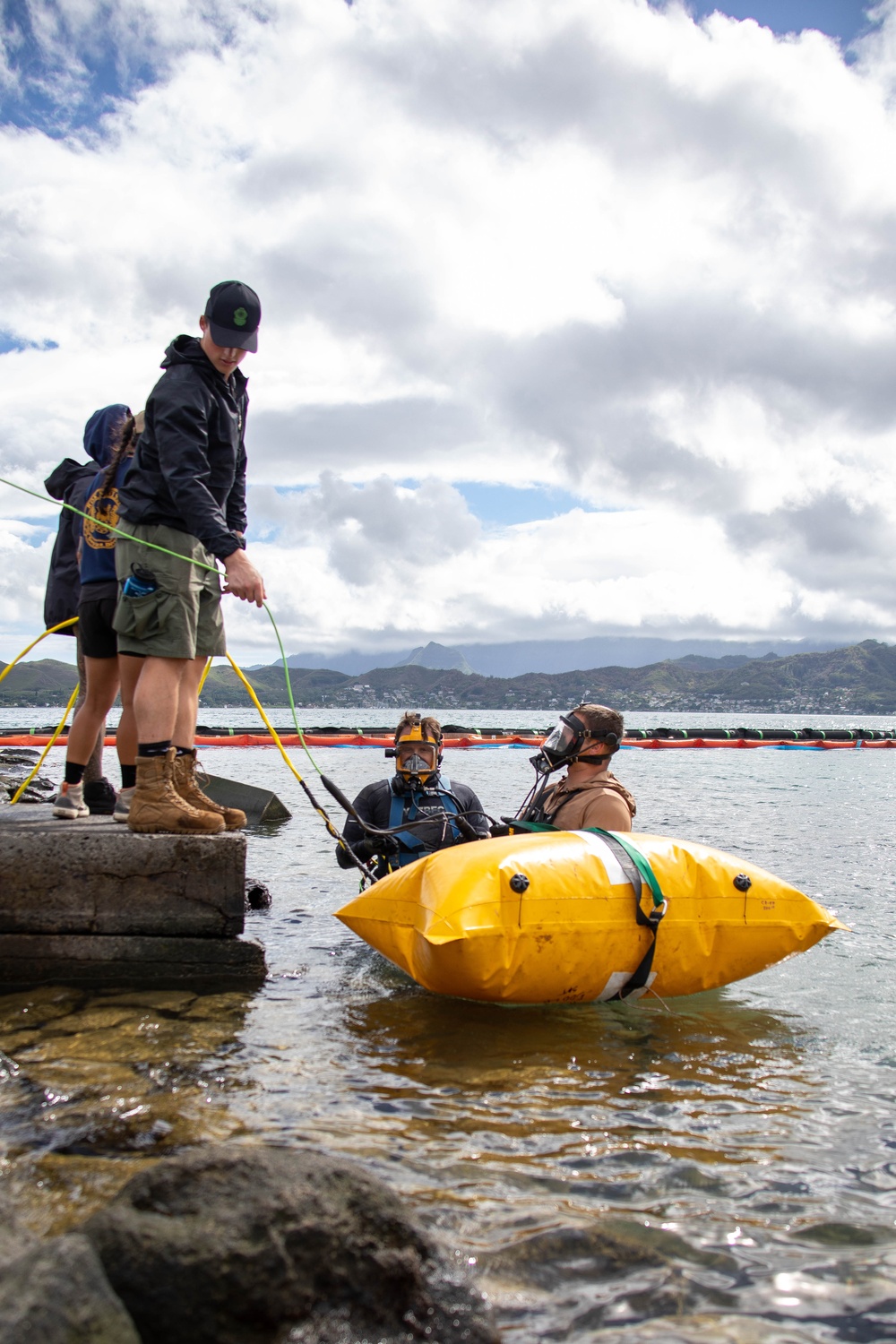 Experts prepare a U.S. Navy P-8A Poseidon in Kaneohe Bay for Salvage Operations