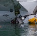 Experts prepare a U.S. Navy P-8A Poseidon in Kaneohe Bay for Salvage Operations