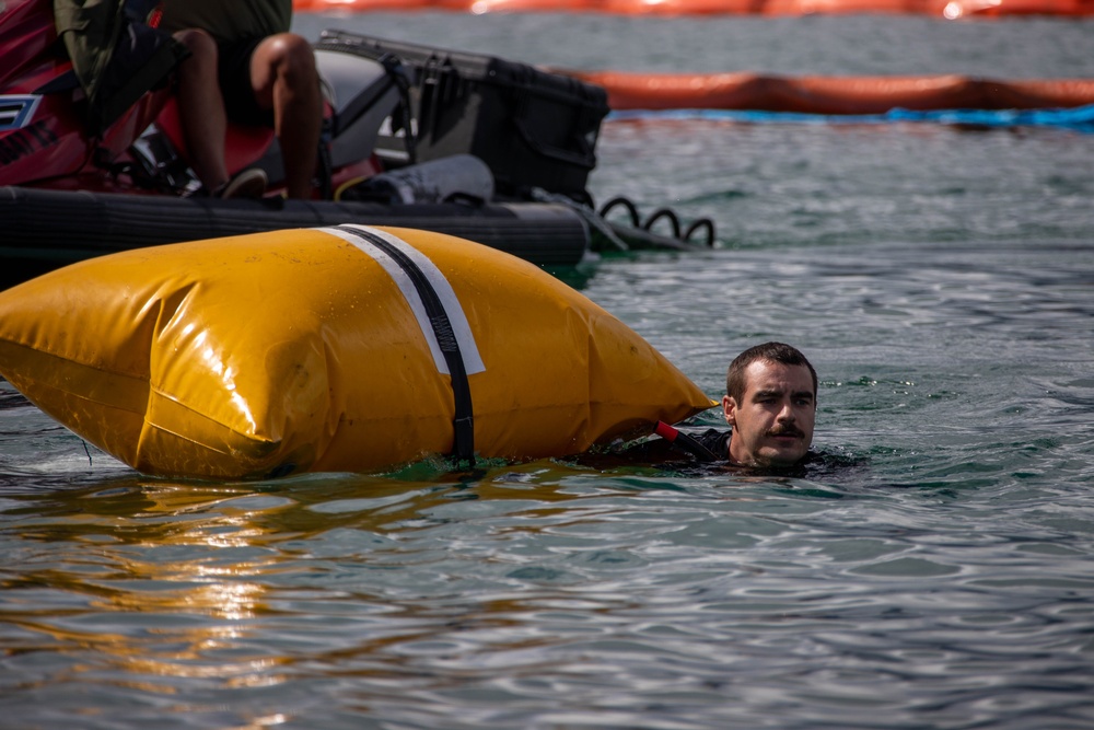 Experts prepare a U.S. Navy P-8A Poseidon in Kaneohe Bay for Salvage Operations