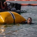 Experts prepare a U.S. Navy P-8A Poseidon in Kaneohe Bay for Salvage Operations