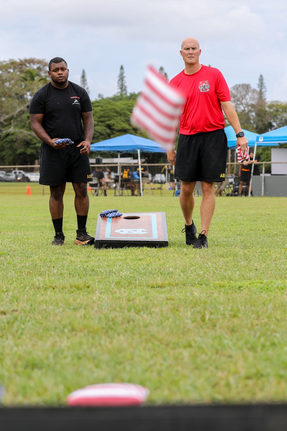 U.S. Army Soldiers from the 130th Engineer Brigade compete in corn hole