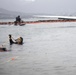 Experts prepare a U.S. Navy P-8A Poseidon in Kaneohe Bay for Salvage Operations