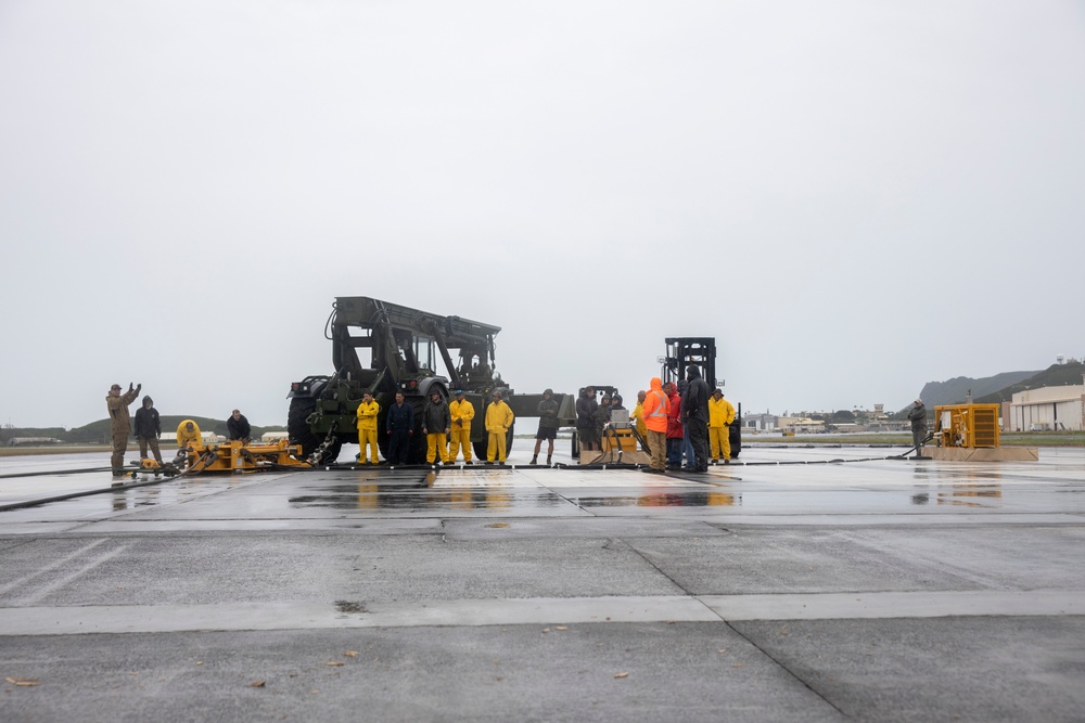 Experts prepare a U.S. Navy P-8A Poseidon in Kaneohe Bay for Salvage Operations