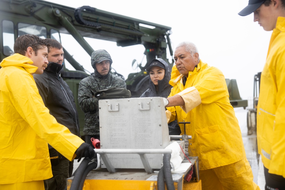 Experts prepare a U.S. Navy P-8A Poseidon in Kaneohe Bay for Salvage Operations