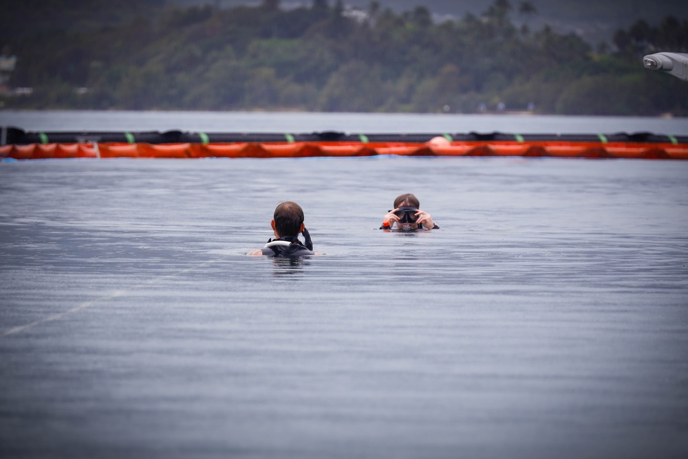 Experts Position Salvage Roller Bags During Salvage Preparation of U.S. Navy P-8A Poseidon in Kaneohe Bay.