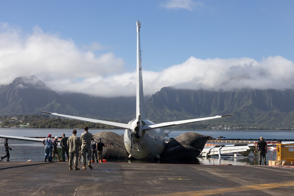 Salvage Team Positions U.S. Navy P-8A Poseidon for extraction from Kaneohe Bay.