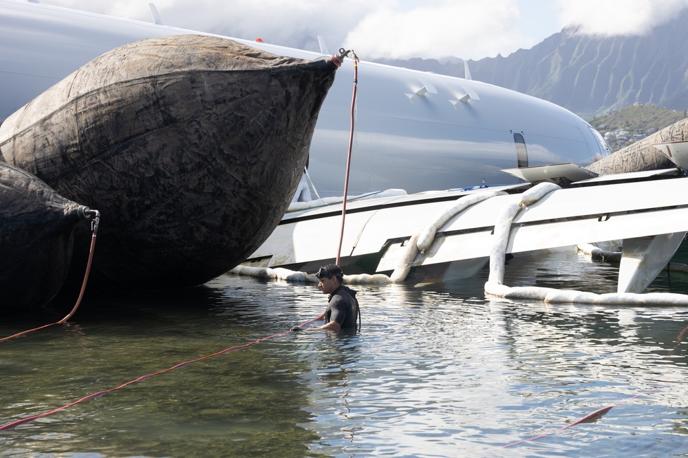 Salvage Team Positions U.S. Navy P-8A Poseidon for extraction from Kaneohe Bay.