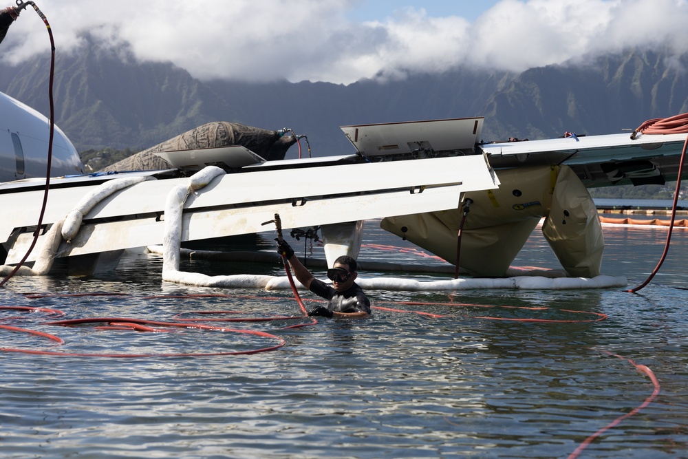 Salvage Team Positions U.S. Navy P-8A Poseidon for extraction from Kaneohe Bay.