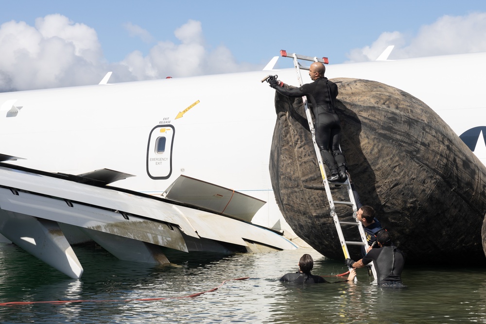 Salvage Team Positions U.S. Navy P-8A Poseidon for extraction from Kaneohe Bay.