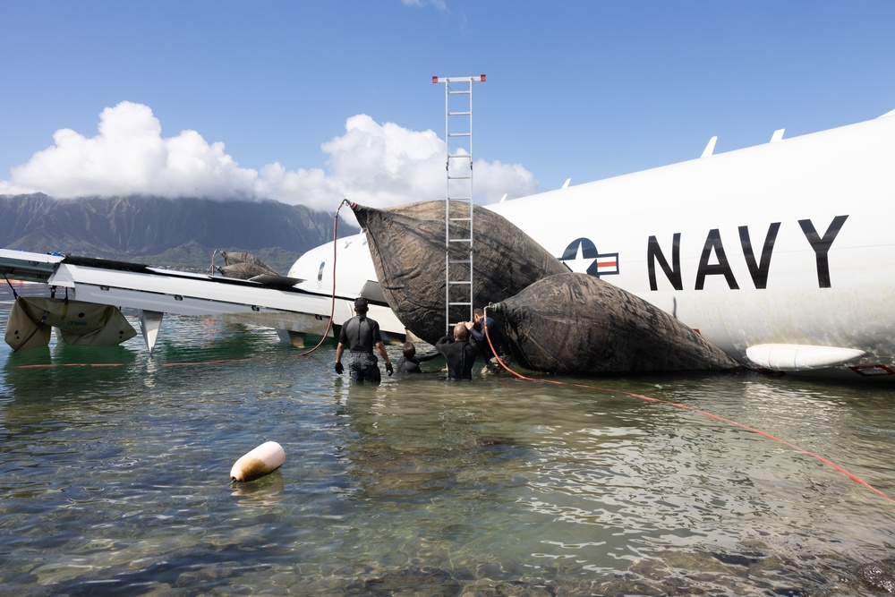Salvage Team Positions U.S. Navy P-8A Poseidon for extraction from Kaneohe Bay.