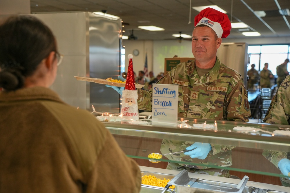 The 114th Fighter Wing leadership serve holiday meal to Airmen