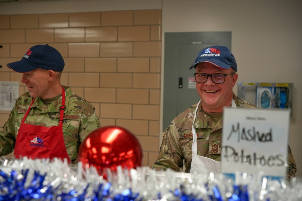 The 114th Fighter Wing leadership serve holiday meal to Airmen