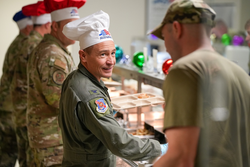 The 114th Fighter Wing leadership serve holiday meal to Airmen