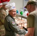 The 114th Fighter Wing leadership serve holiday meal to Airmen