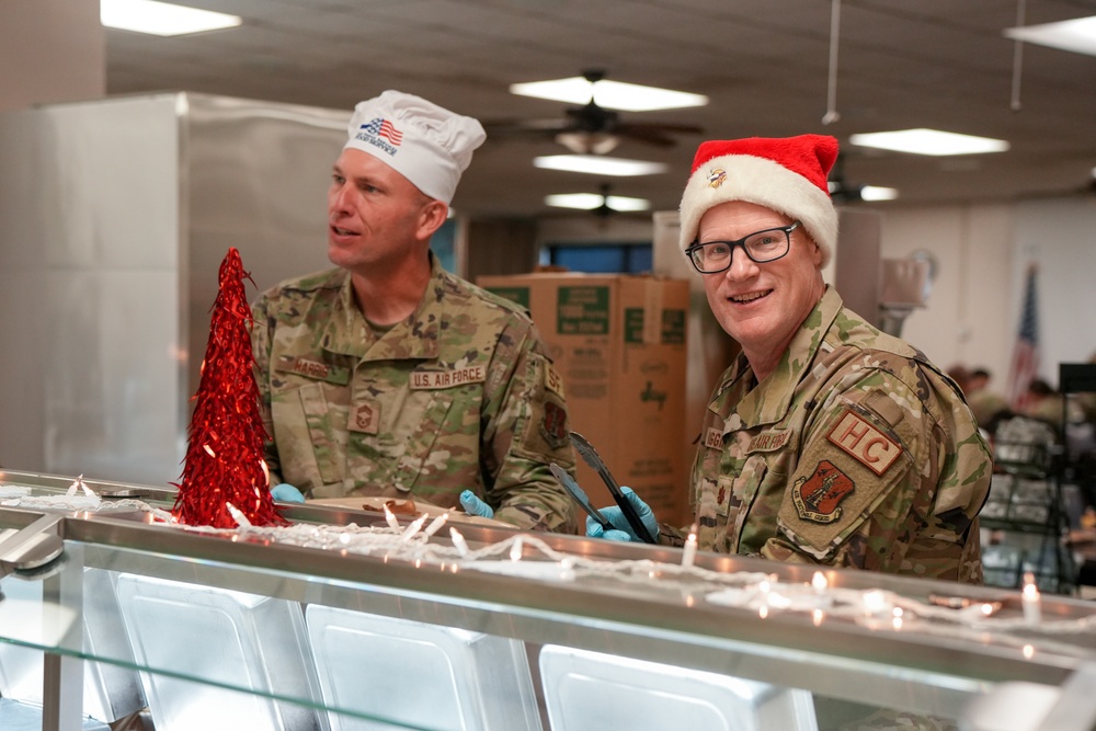 The 114th Fighter Wing leadership serve holiday meal to Airmen