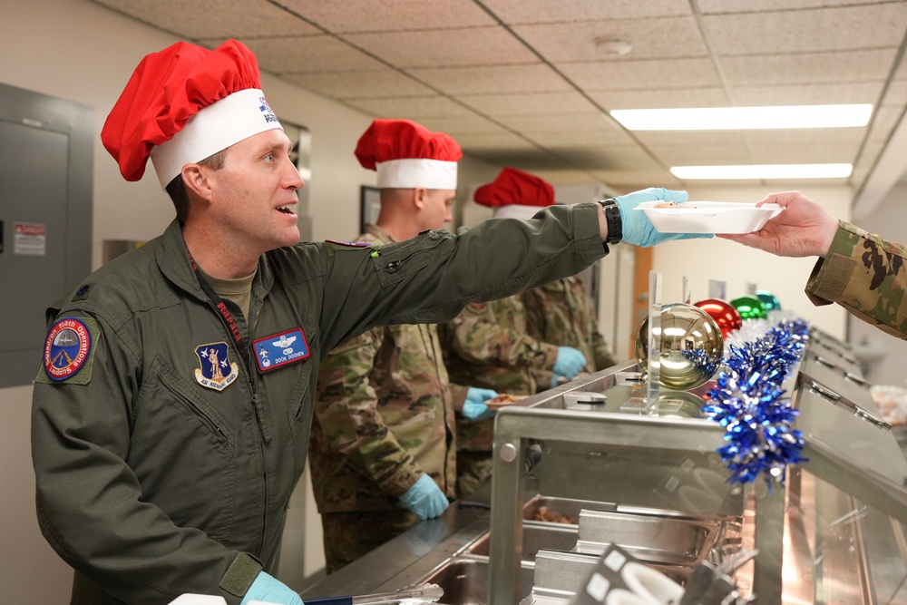 The 114th Fighter Wing leadership serve holiday meal to Airmen