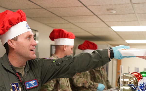The 114th Fighter Wing leadership serve holiday meal to Airmen