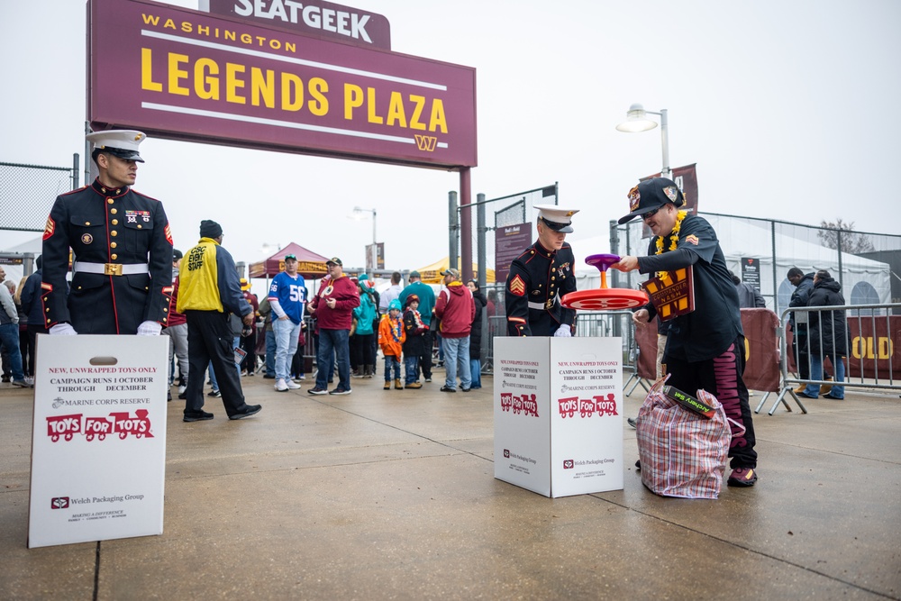 U.S. Marines with Marine Corps Base Quantico and Marine Corps Forces Reserve participate in the Toys for Tots toy drive at the Washington Commanders football game