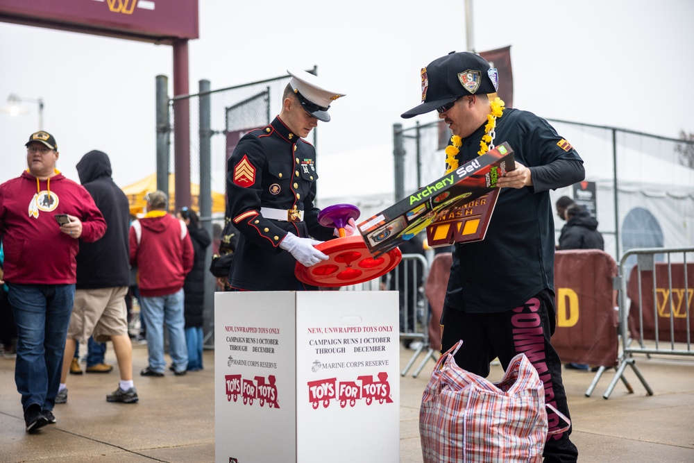 U.S. Marines with Marine Corps Base Quantico and Marine Corps Forces Reserve participate in the Toys for Tots toy drive at the Washington Commanders football game