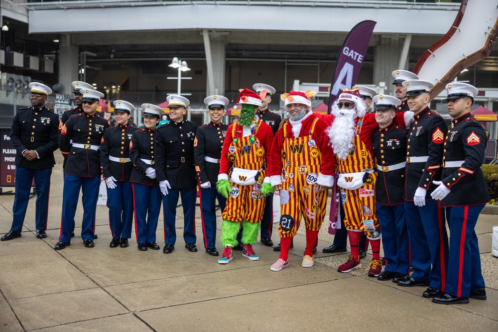 U.S. Marines with Marine Corps Base Quantico and Marine Corps Forces Reserve participate in the Toys for Tots toy drive at the Washington Commanders football game