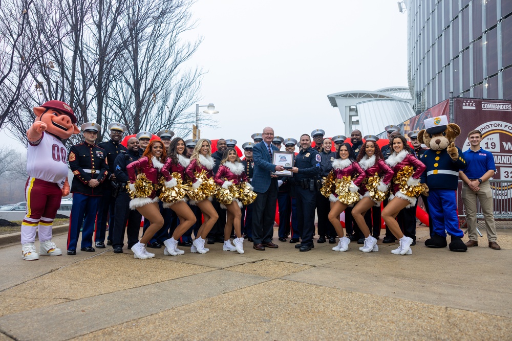 U.S. Marines with Marine Corps Base Quantico and Marine Corps Forces Reserve participate in the Toys for Tots toy drive at the Washington Commanders football game