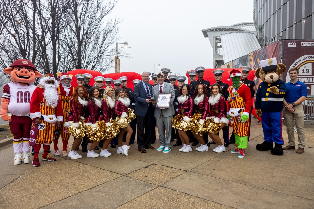 U.S. Marines with Marine Corps Base Quantico and Marine Corps Forces Reserve participate in the Toys for Tots toy drive at the Washington Commanders football game