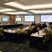 Rear Adm. John Menoni, acting commander of Navy Installations Command (CNIC) speaks to region commanders and leadership during the annual CNIC Executive Steering Committee