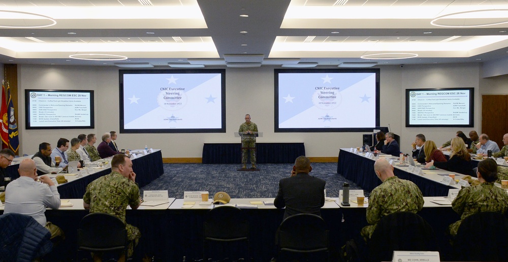 Rear Adm. John Menoni, acting commander of Navy Installations Command (CNIC) speaks to region commanders and leadership during the annual CNIC Executive Steering Committee