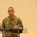 Rear Adm. John Menoni, acting commander of Navy Installations Command (CNIC) speaks to region commanders and leadership during the annual CNIC Executive Steering Committee