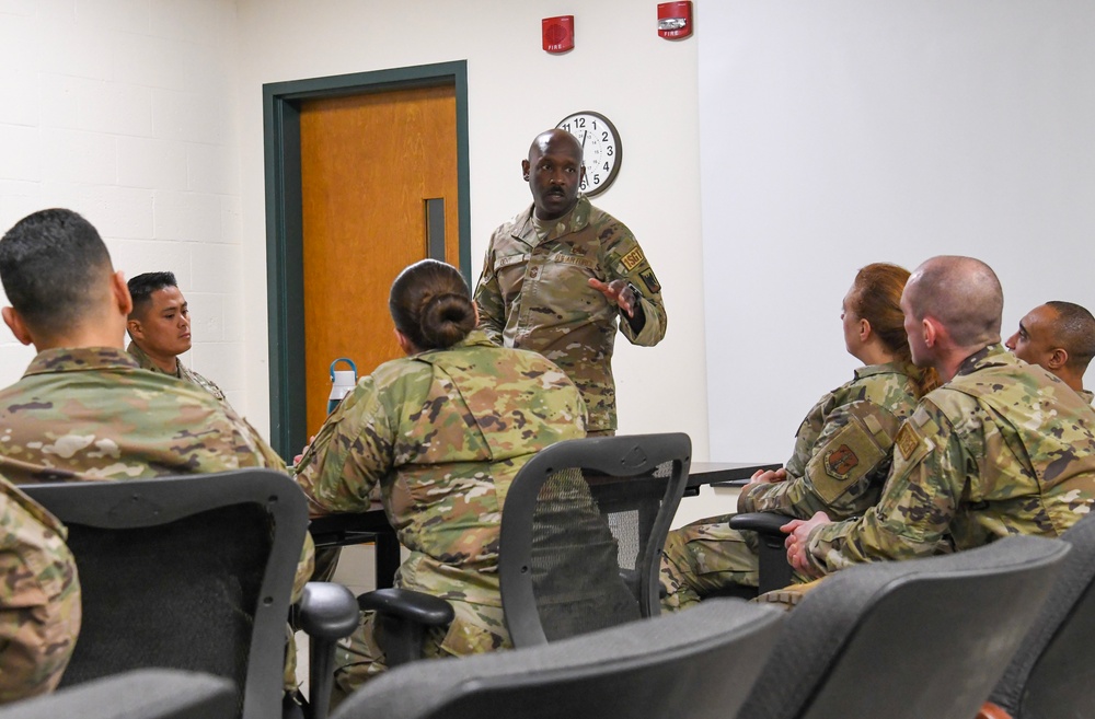 U.S. Air Force Chief Master Sgt. Aaron Dent speaks with first sergeants assigned to the 106th Rescue Wing