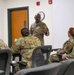 U.S. Air Force Chief Master Sgt. Aaron Dent speaks with first sergeants assigned to the 106th Rescue Wing