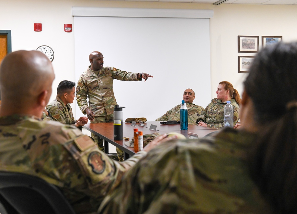 U.S. Air Force Chief Master Sgt. Aaron Dent speaks with first sergeants assigned to the 106th Rescue Wing