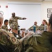 U.S. Air Force Chief Master Sgt. Aaron Dent speaks with first sergeants assigned to the 106th Rescue Wing