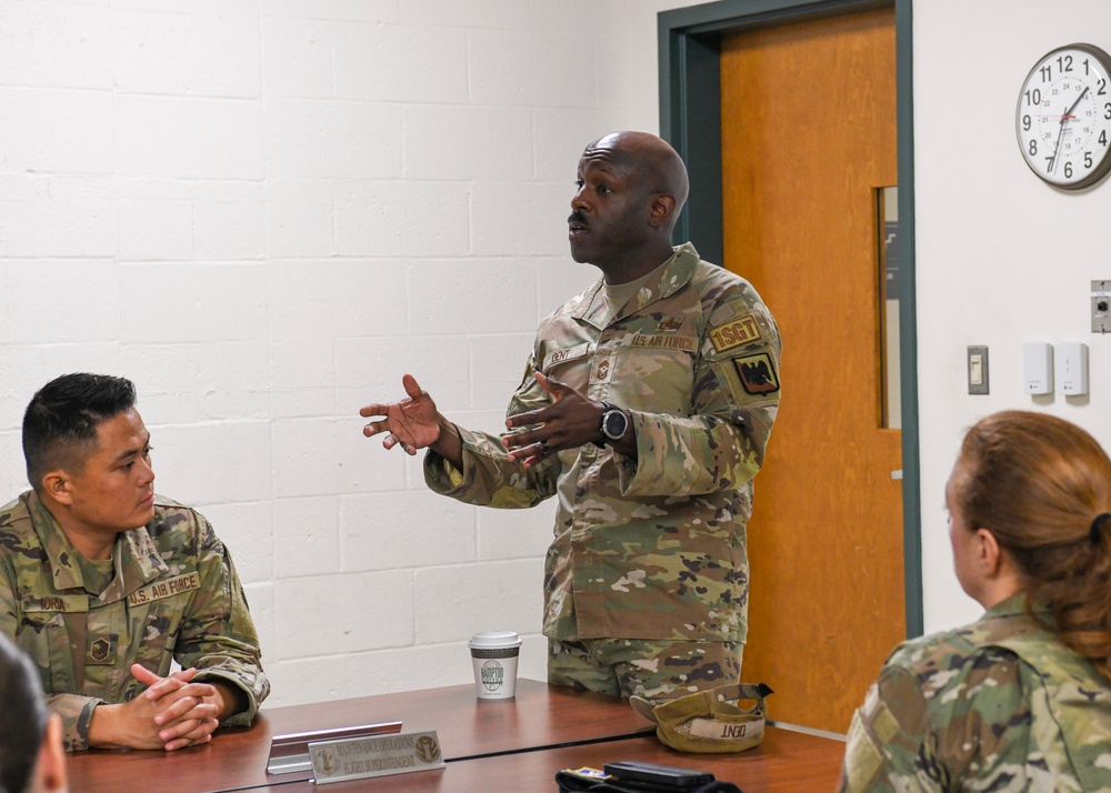 U.S. Air Force Chief Master Sgt. Aaron Dent speaks with first sergeants assigned to the 106th Rescue Wing