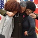 Sgt. Maj. Felix Lassus gives his daughters a big hug after a retirement ceremony